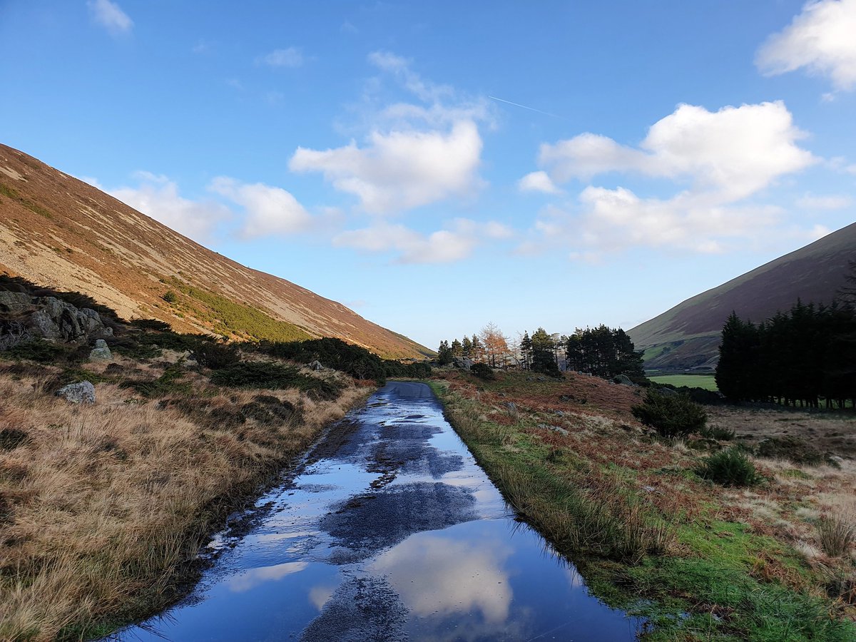 Blue sky and clouds reflected in the puddles