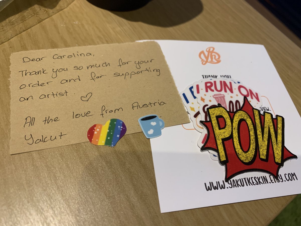 Some stickers next to a card from the artist thanking me for the support.