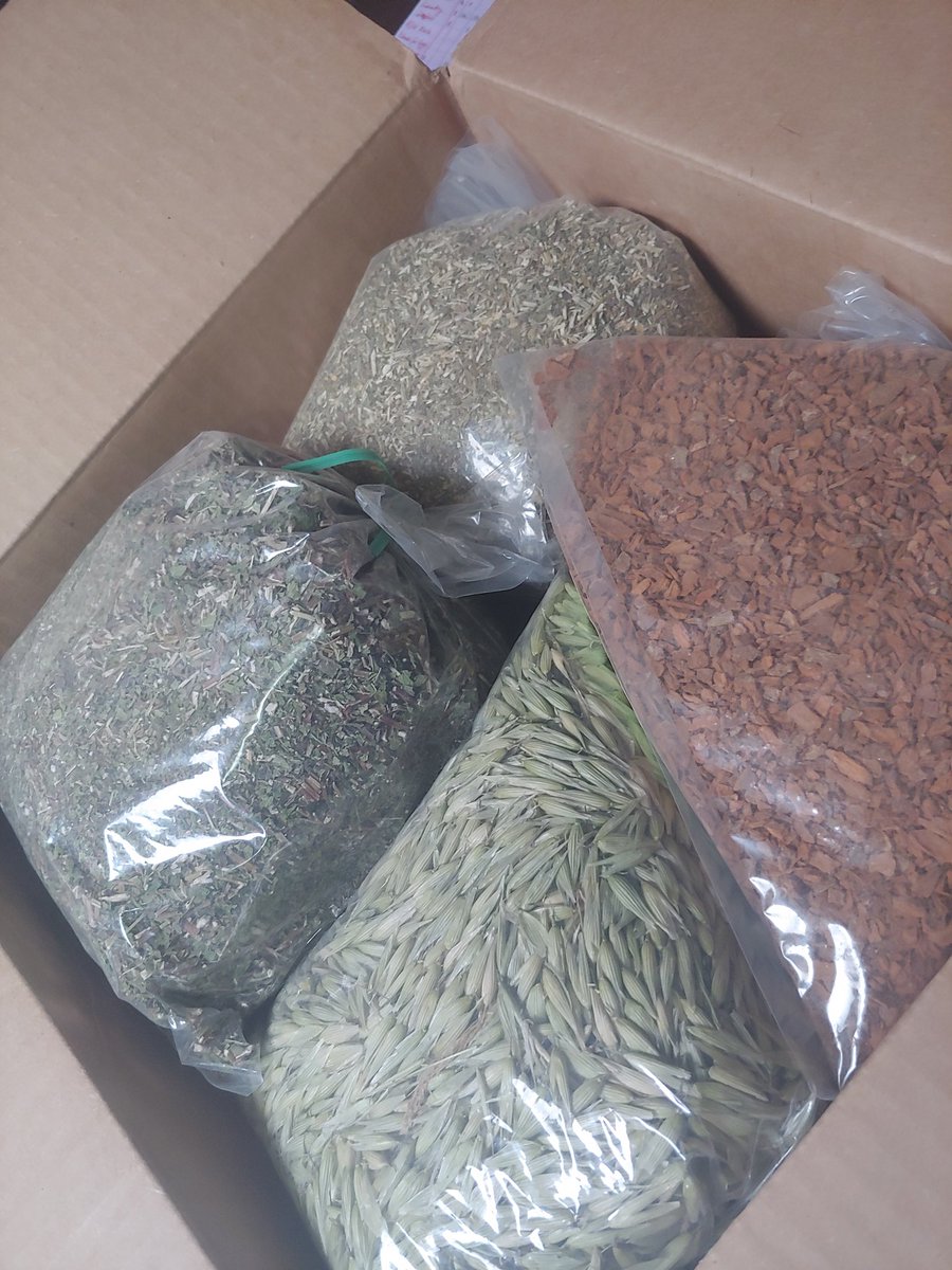 Center angle of the top of a box, open, filled with bags of herb matter.