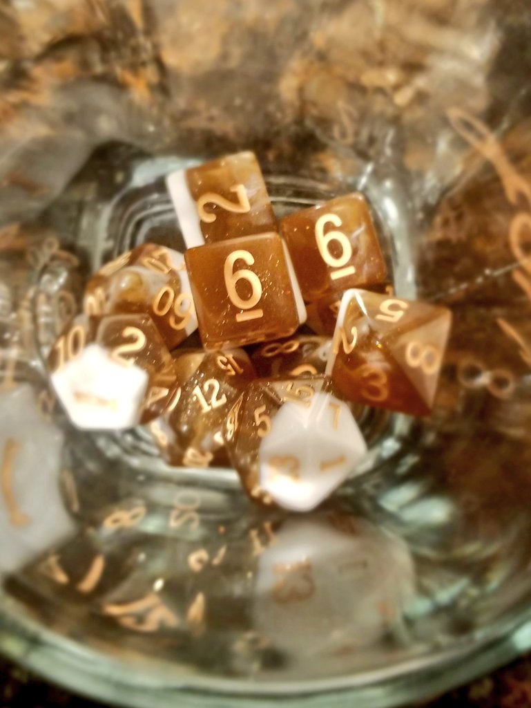 Shot of dice in a glass cup.