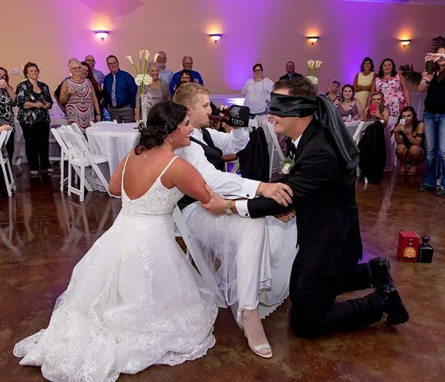 LolaDeePhoto's tweet photo. There are so many things I love about this photo!! 😂 From the groomsman who stepped in for the garter undressing to fool the blindfolded groom, dedicated by even wearing white hose, to the backup alcohol in the background on standby - what a moment!!… https://t.co/FhBquNVD2G https://t.co/6CNXYqNN6a