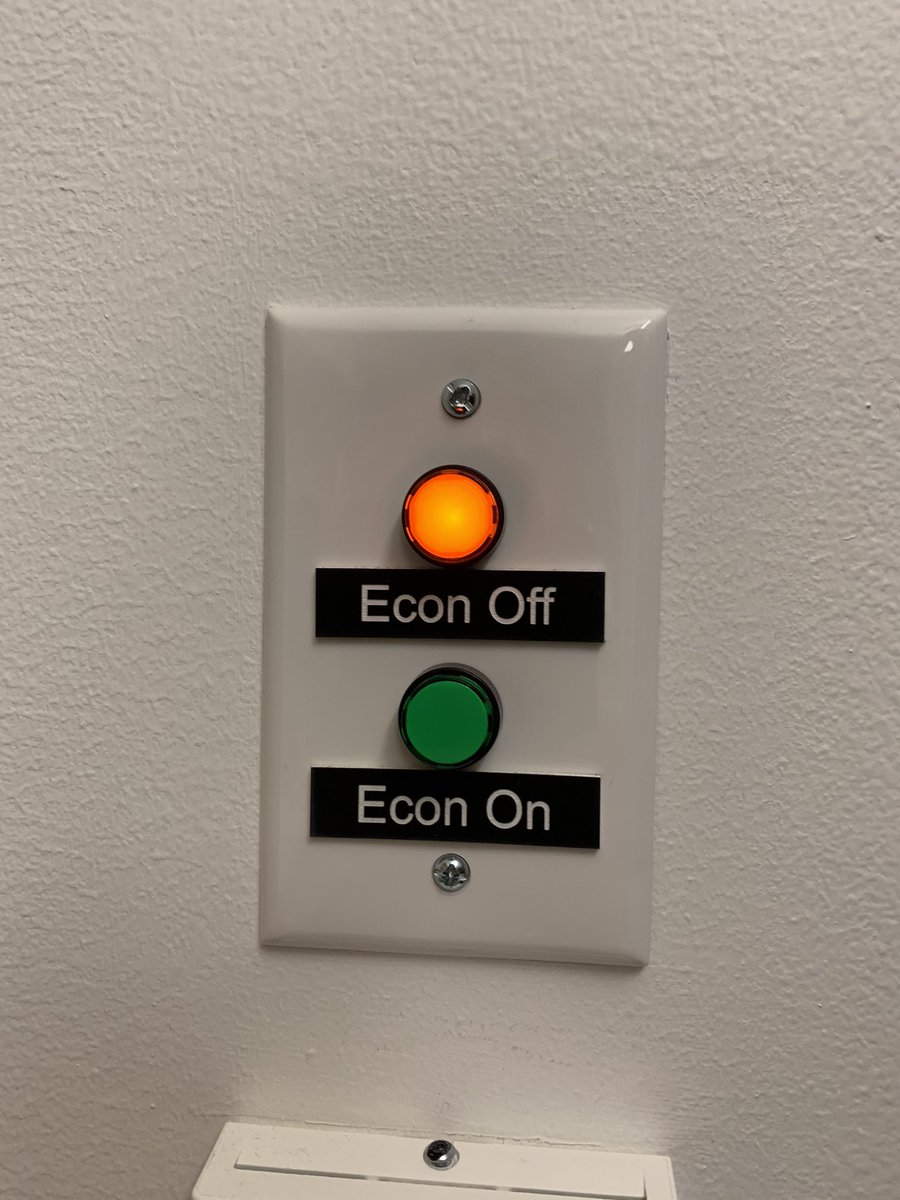 a wall mounted pair of red and green buttons labeled "Econ off" and "econ on"