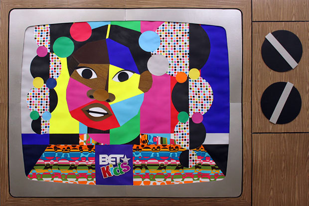 Collage of bright paper that looks like Rudy Huxtable set in a TV