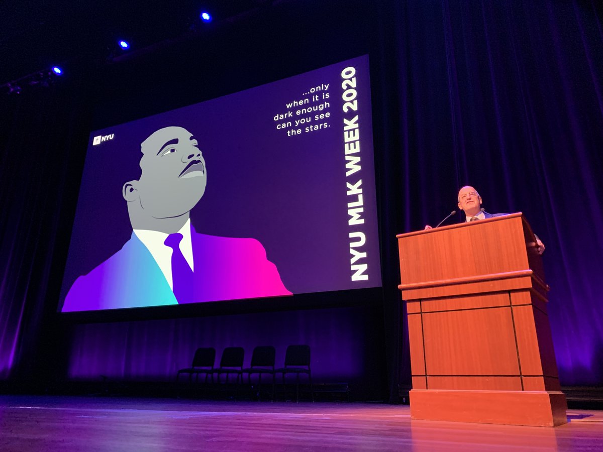 President Andy Hamilton at a podium in front of the screen with Martin Luther King, Jr. on it