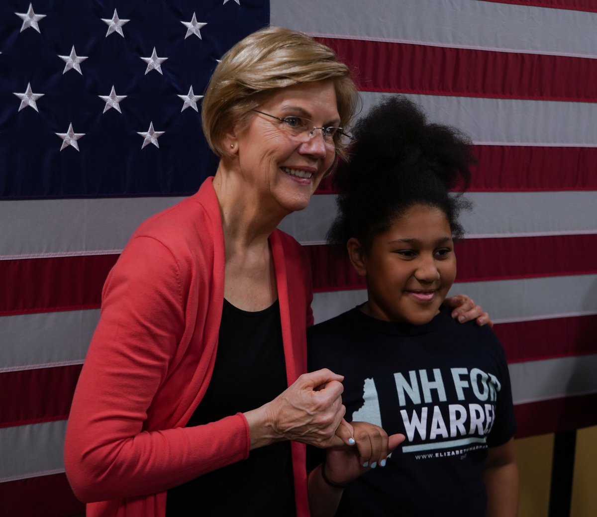 Elizabeth Warren makes a pinky promise at the Derry town hall.