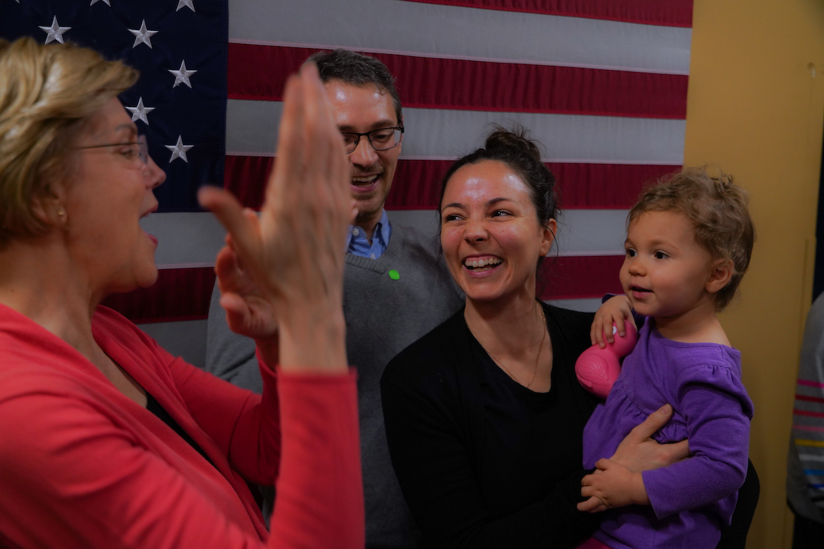 Elizabeth Warren greets a family at the Derry town hall.
