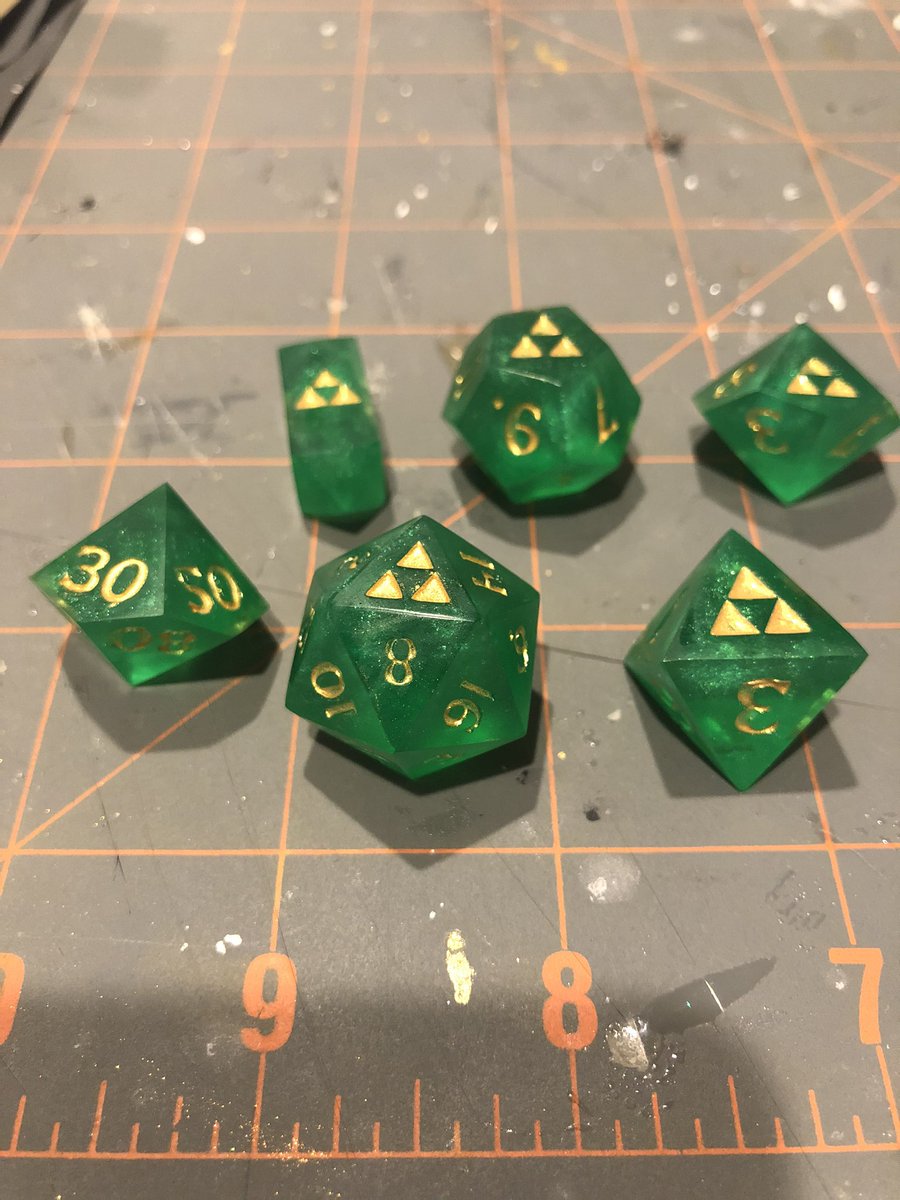 hardlightforge's tweet image. Gross lighting and my sad gross craft mat, but a sexy new set of kokiri dice with its first layer of ink almost ready to go to their new home. #diceporn #handmadedice #dice #dnd #LegendofZelda #triforce #BreathoftheWild2 #breathofthewild #loz #dnd5e