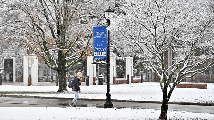 A student walks along Old Main Circle today, Feb. 7, with MTSU's Uranidome and the Cope Administration Building in the distance during Murfreesboro's first significant snowfall of 2020. (MTSU photo by J. Intintoli)