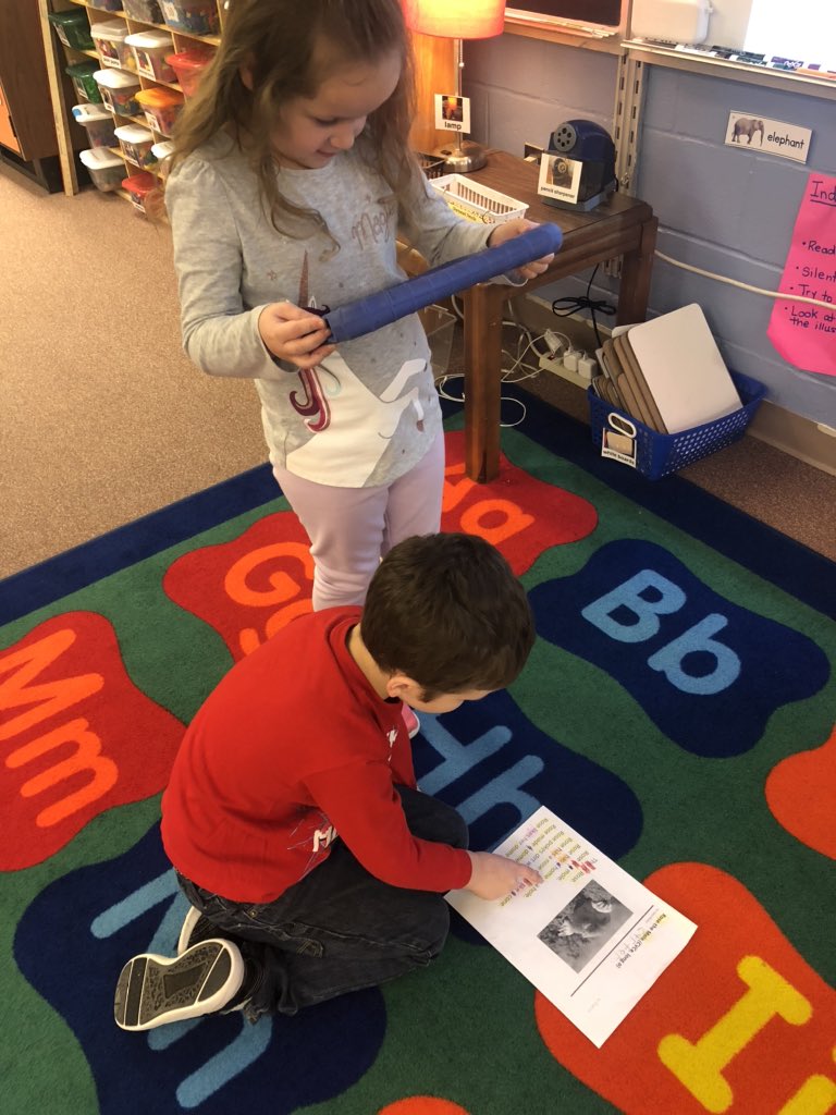 Ks recording a passage to share their  fluency skills with parents on <a href="/Seesaw/">Seesaw</a> #wcpsreads #gberocketeers