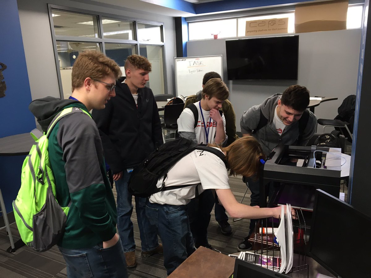 Associates working on a team 3D printing project.