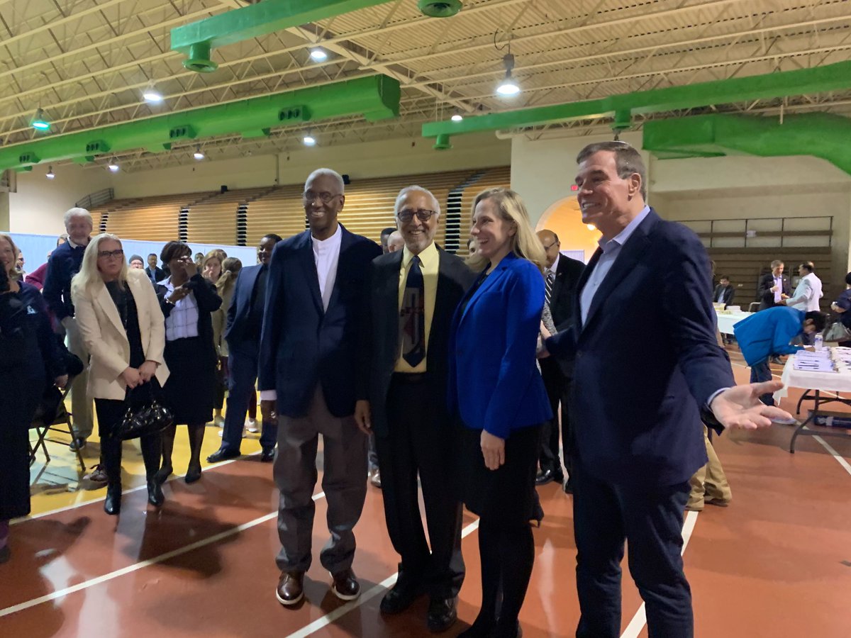 Representative Donald McEachin, Khizr Khan, Representative Abigail Spanberger, and Senator Mark Warner stand together at a rally in Richmond, Virginia.