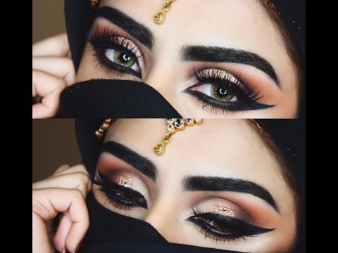 Ishizu not as heavily highlighted as Marik but wears fairly similar makeup otherwise, just toned down and smoked out, and without his extreme graphic liner (tho still quite bold!!!)