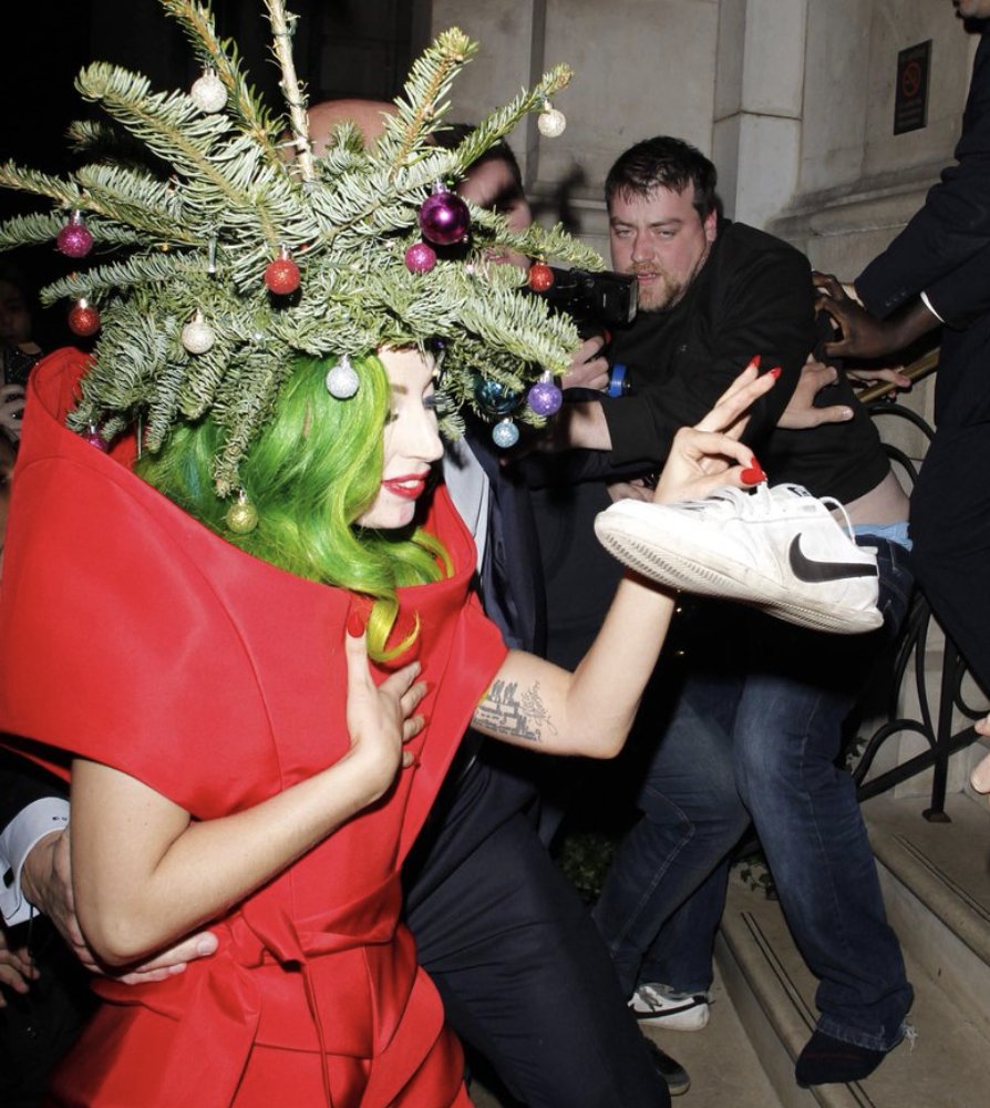 15. lady gaga stealing a shoe from a photographer while dressed as a christmas tree