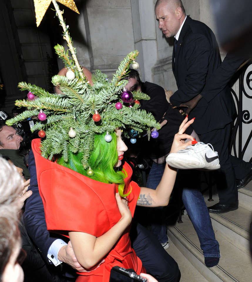 15. lady gaga stealing a shoe from a photographer while dressed as a christmas tree