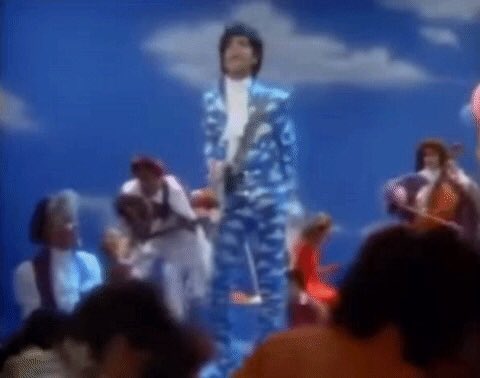 The blue sky is eye catching on the cover and also on the Raspberry Beret video where he is wearing that sky blue suit with clouds on it.