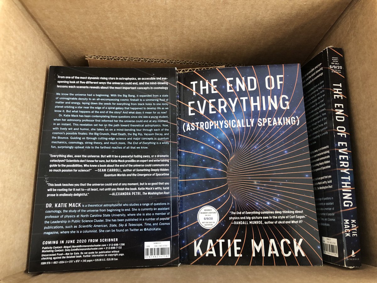 A box of books! One face-down, one face-up, one on its side showing the spine. The title is “The End of Everything (Astrophysically Speaking)”
