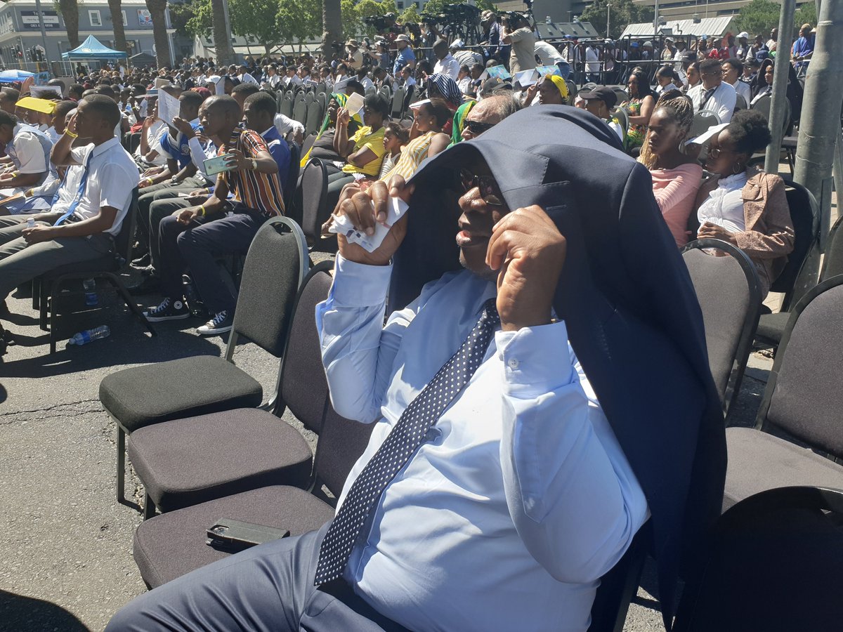 AthiMtongana's tweet photo. Gauteng Education MEC, Panyaza Lesufi has left the comfort of the VIP tent to sit with school pupils in the scorching Cape Town sun. 

Lesufi says this is solidarity with the pupils. 

#MandelaReturns https://t.co/a5sRgK6Yo3