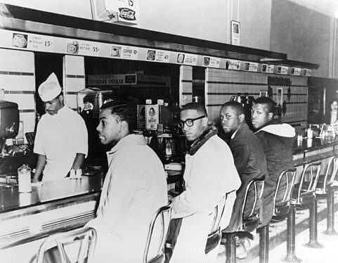 BitterSouth's tweet image. In an iconic photo from 60 years ago, four young African American men sit at a Woolworth’s lunch counter and stare resolutely back at the photographer behind them. Behind the counter is a young busboy. His name was Charles Bess. Today, his story. bittersoutherner.com/southern-persp…