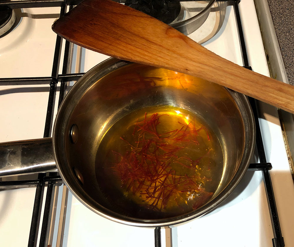 Having macerated saffron for earlier tests, I can definitely say decoction is MUCH more efficient to draw out the colour.