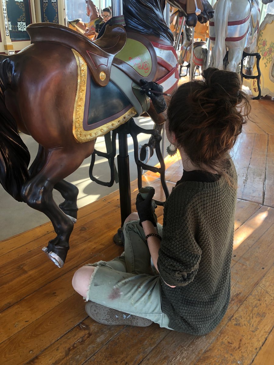 Did you know our Carousel is staffed by many talented young artists? You might recognize Sarah in this photo, one of our lovely operators putting her skills towards fixing up the horses this season.