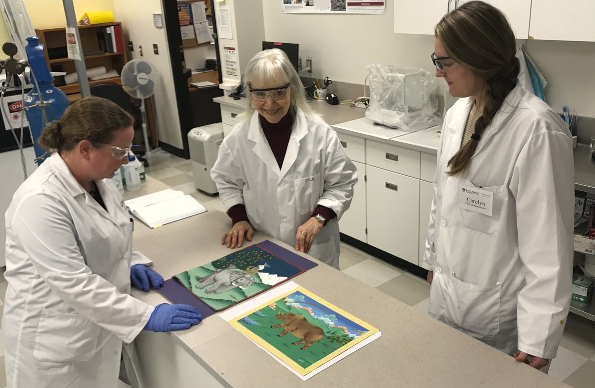 Prof. Christa Brosseau and student Carolyn Farling examining paintings included in our upcoming exhibit, SCIENCE AND THE SACRED at the Chase Gallery in March. Raman Spectrometer revealed a mix of natural and synthetic pigments. thangkapreservation.com treasurecaretaker.com
