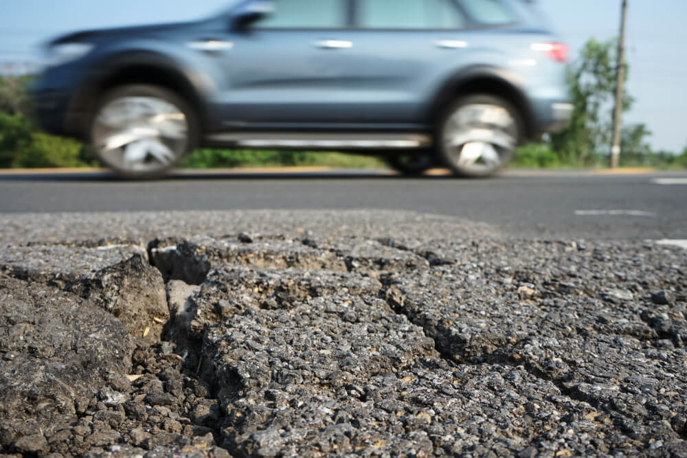 swiftsurfacing's tweet photo. Residents in East Sussex discovered what could only be described as one of the largest potholes in the UK...  This 10ft long hole in the road has truly broken the record for the largest pothole we have ever seen!  - https://t.co/dLpMbOnV0g https://t.co/4y56nXC6X0
