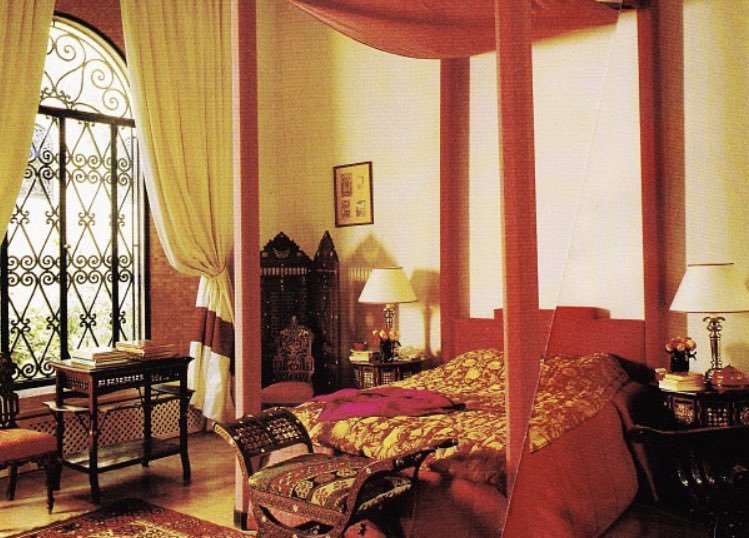 In this delightful room, the bed frame is covered in red silk from Le Manach while the bed cover was made of brocade. Jacqueline had embroidered red panels set into the white tarpaulin curtains. All the furniture is Syrian.