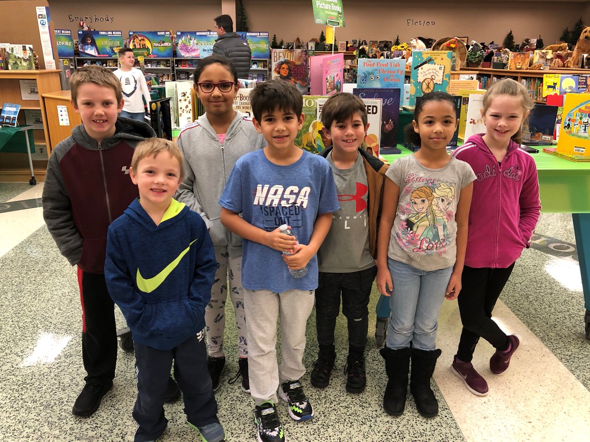 Seven StaRRR students and a sneak peek of our Jungle Book Fair in the background!