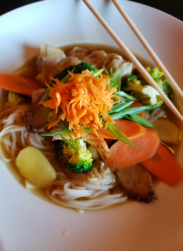 Wor Wonton Soup!! A big bowl of savory deliciousness. Tender pork wontons, carrots, shrimp, BBQ pork, ginger, water chestnuts and rice noodles in a rich flavourful broth. $16
