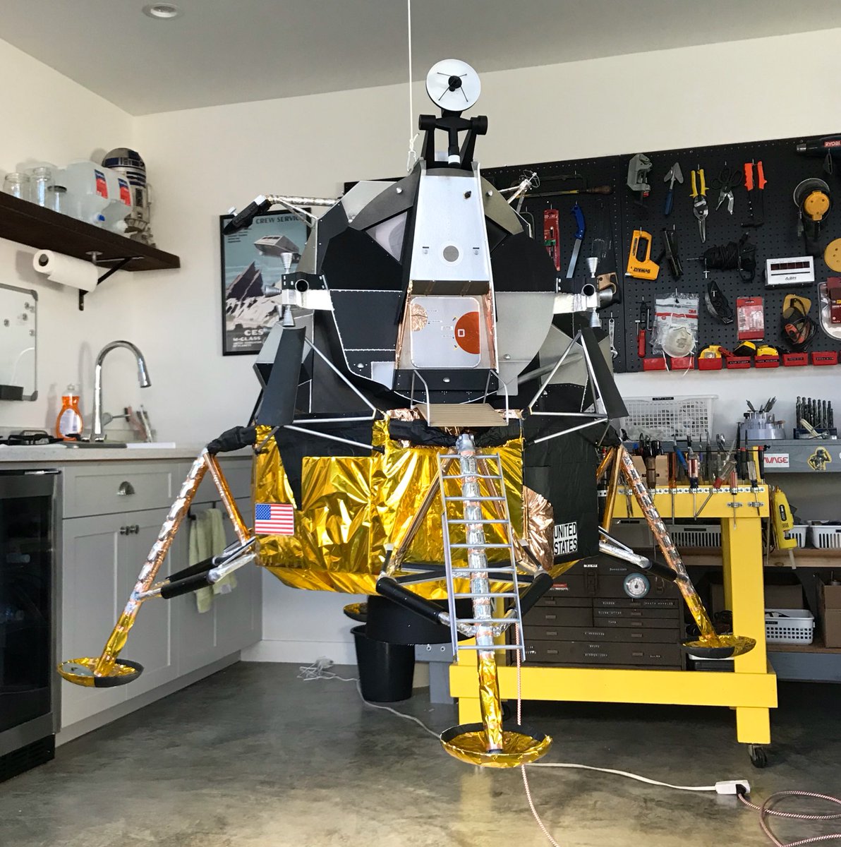 I made a 1/6 scale lunar module chandelier for my shop. It’s 5’ across and there’s an LED bulb in the engine bell. I scratch-built it mostly from painted foam core and 3D printed parts. It’s going to hang from the ceiling along with my Gemini astronaut.