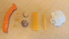 Swammingly's tweet photo. A minimalist photo of the BEST #eCheese products! From left to right, Crunchy #eCheese, 3 drops of #eCheese soda, #eCheese's Puffs, #eCheese Cheddar (sliced and shredded), and a dollop of Whipped #eCheese Cream. Thanks @CliffyCheese for blessing us with so many amazing products! https://t.co/zJXhtV54Ei