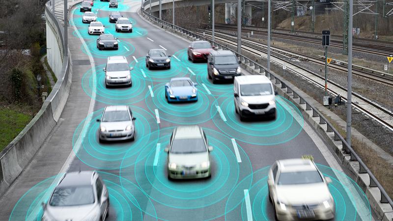 Stock image of vehicles on a freeway - each emitting virtual illustrated waves. 