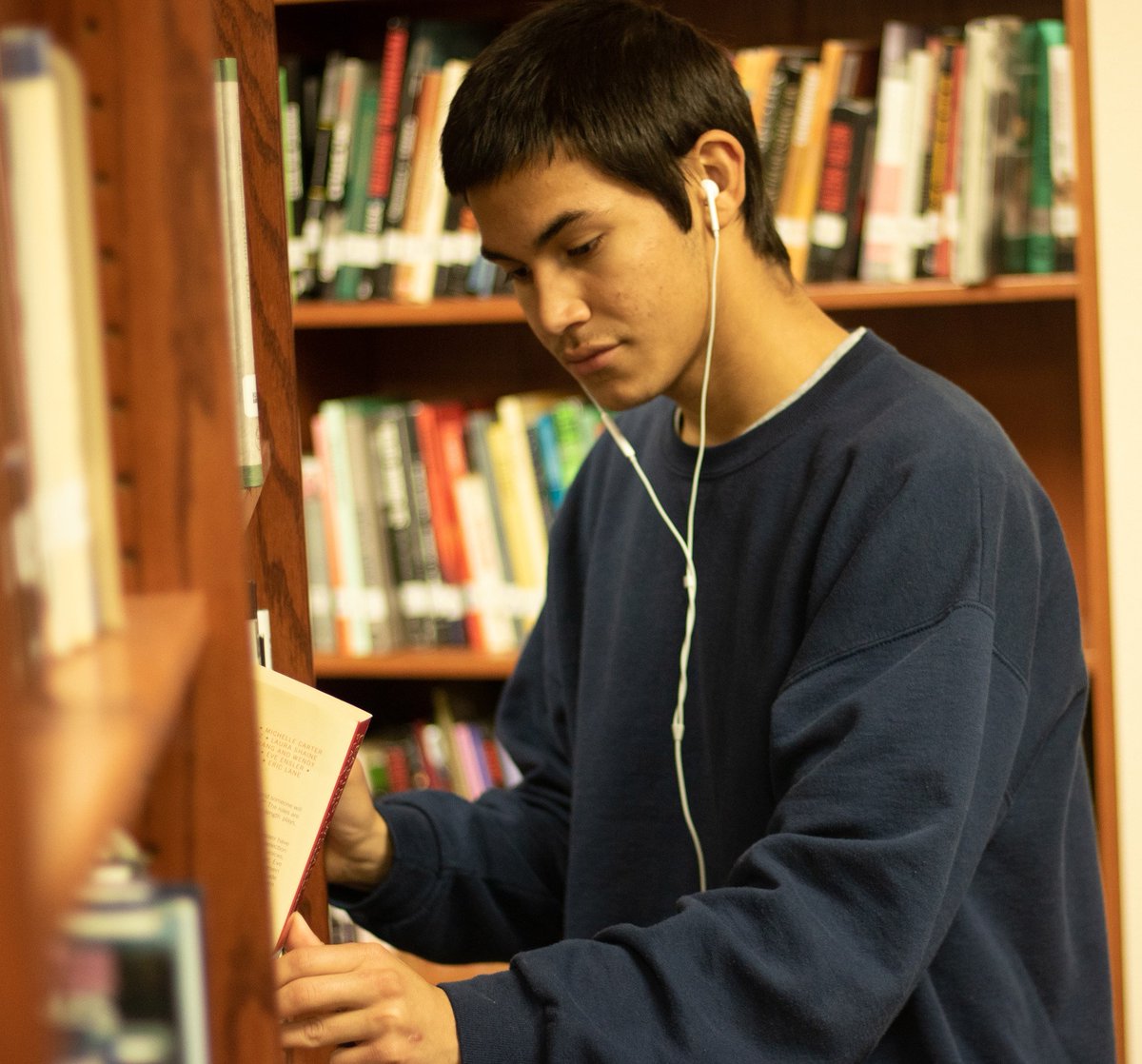 JSHSMedia's tweet image. Analyzing, sophomore Diego Alvarez checks out books to read in the library on Feb 12. The library is open from 7 a.m. to 3 p.m. every school day.
