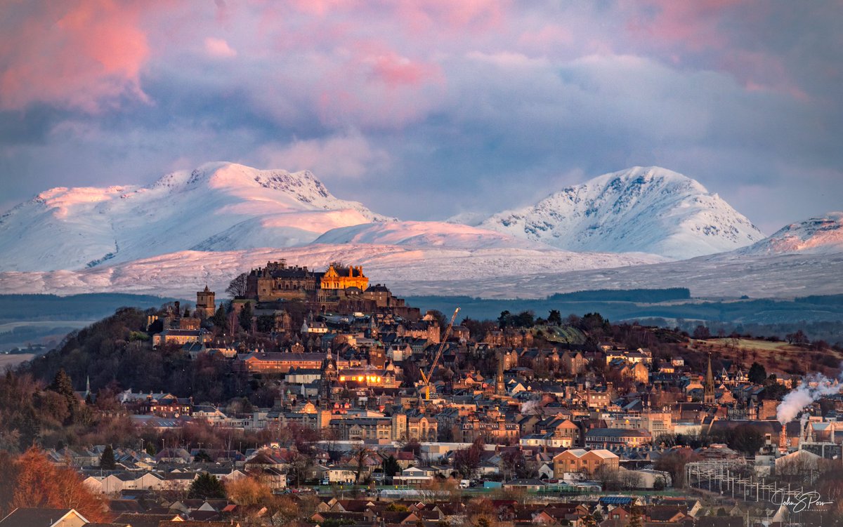I took this yesterday morning.  I think it is one of the best views in Scotland - Stirling with the castle watching over the city while snow covered Ben Vorlich and Stuc a’Chroin stand proud behind. The blush of the morning sunrise was the icing on the cake.