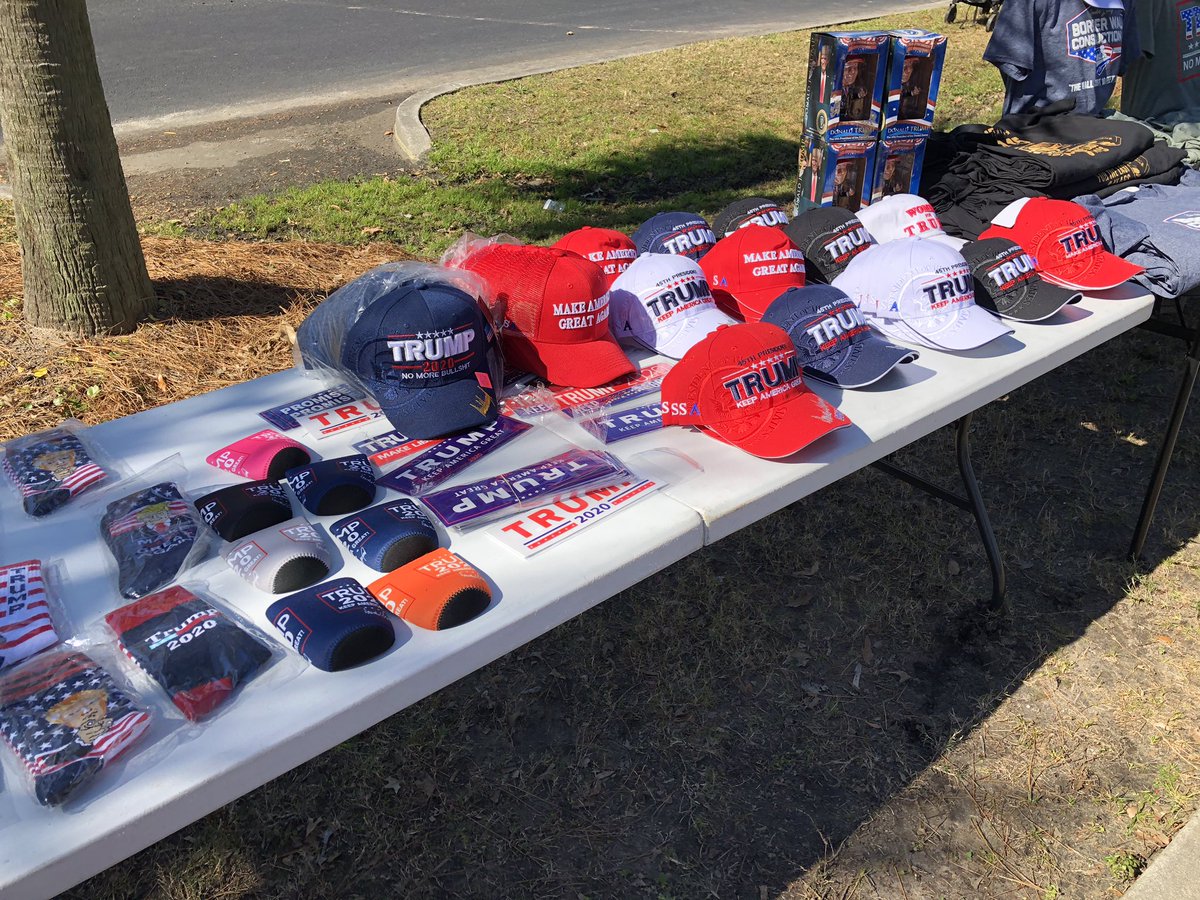 thestate's tweet photo. Some of the many pieces of merchandise available for supporters as they wait to be let into the Coliseum. #TrumpinSC https://t.co/exEDHOoBTs