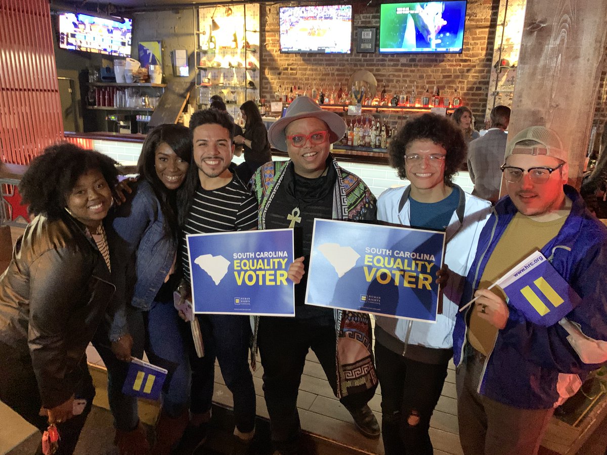 People with HRC North Carolina Equality Voter signs and flags