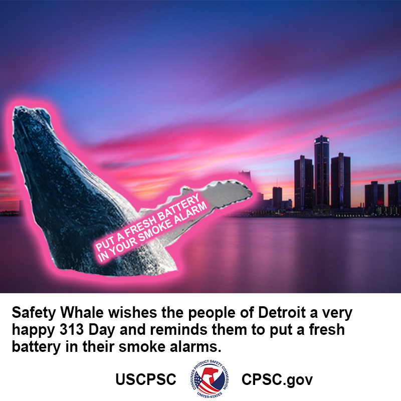 A whale breaching in the Detroit harbor. The text on the whale's fin reads: put a fresh battery in your smoke alarm.