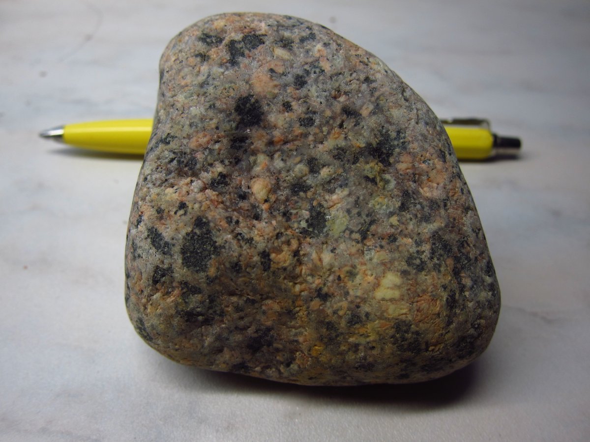 This pebble is not "probably from", but surely from Sorsele area, bc it's Sorsele granite, sometimes cited as part of the Transscandinavian Igneous Belt.It's a monzogranite w porphyritic texture and some magnetite, ca 1.7Ga old, travelled ca 270-300 km.Found in: Umeå (esker).