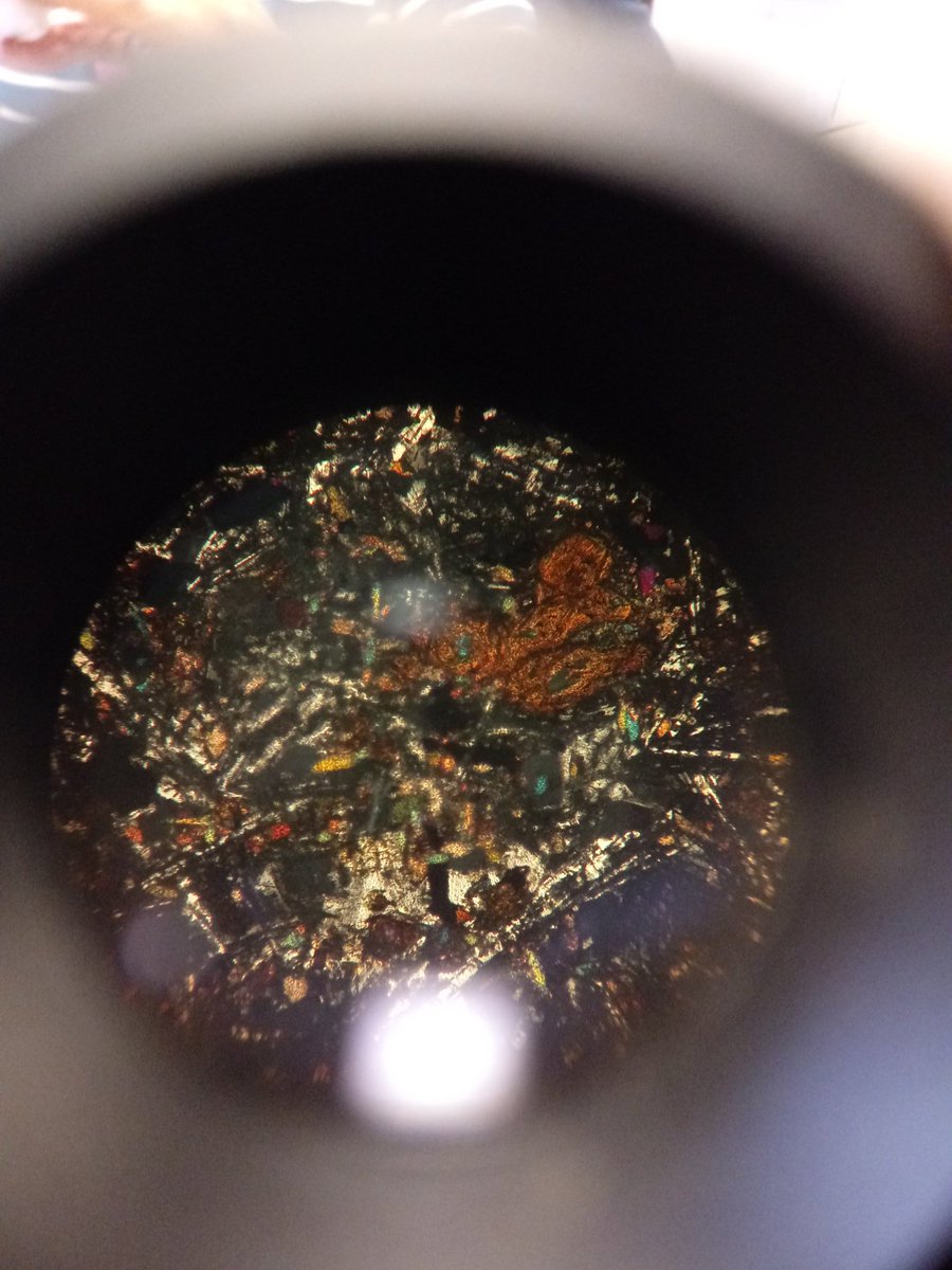 DeeLau1's tweet photo. Spent this Leap Day looking at thin rock sections through the petrologic microscope @LickeyHills classroom. Managed to get a phone pic of what dolerite looks like through crossed polars. Also a good view of pyroxene through plane polarised light #rocks #petrology #OUGS https://t.co/fGgK1qkI3B