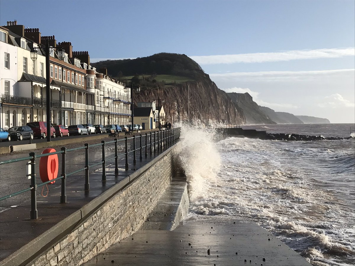 WeathermanSW17's tweet image. Sidmouth sea front this morning looking east with the clearing cold front in the distance.