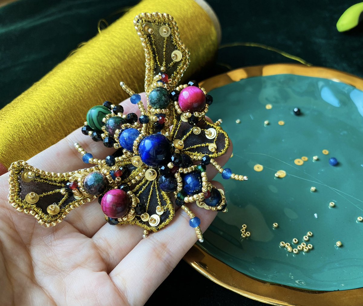 #handcrafted #embroideryjewelry #flybrooch  #handmadejewelry  
Inspired by the beautiful fly, I designed this brooch. The wings are made by embroidery techniques with fine silk, a lot of gemstones are used to finish this jewelry piece.