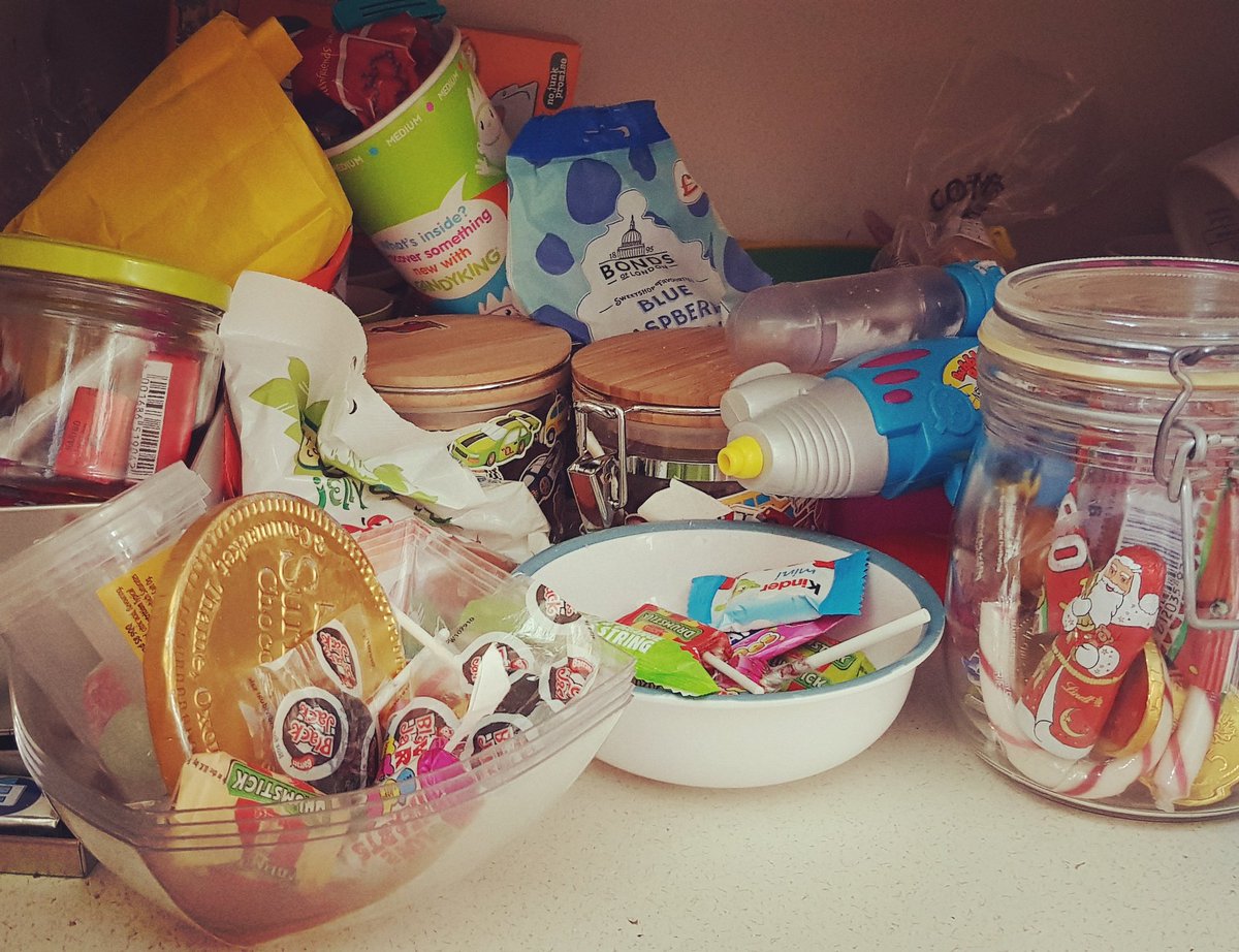 MummyShire's tweet photo. This is my children's sweet cupboard full of half eaten party bag sweets, jars won at school tombolas, partially eaten tubs from the cinema, Halloween buckets. 
AND STILL they want to go to the sweet shop.  I realise now it's ALL about the thrill of the chase 🏃‍♀️
#YESDAY https://t.co/jvblGo1Nsz