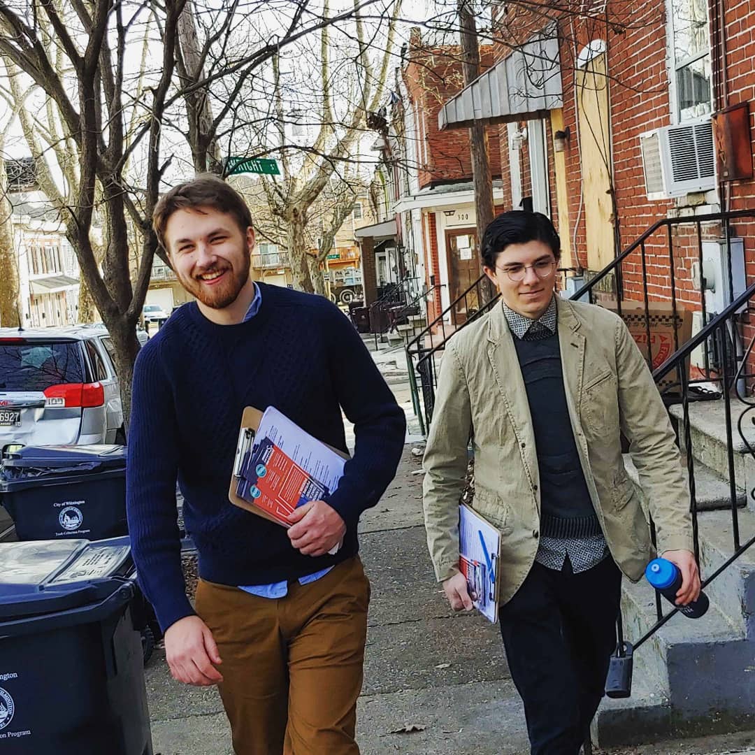 Two volunteers walking on a street in Wilmington, Delaware.