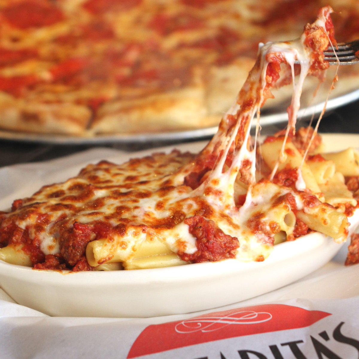 Pizzaritas's tweet photo. Cheese pullin' on our heartstrings. 😍 You can't help but love the Baked Ziti! https://t.co/0MbZLRL0zO