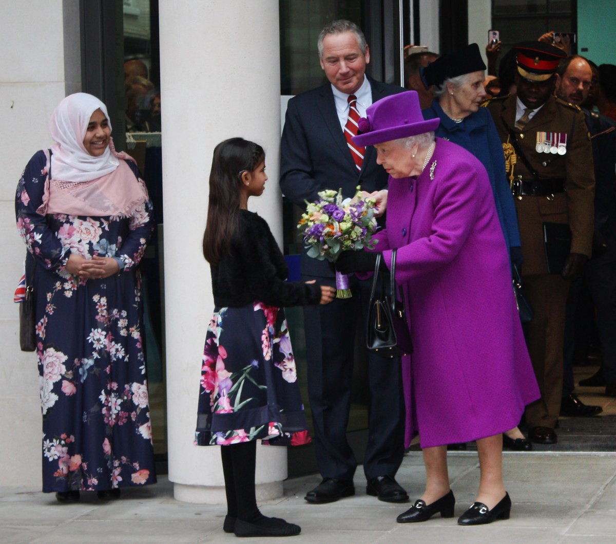 uclh's tweet photo. We were delighted to welcome Her Majesty The Queen to formally open the Royal National ENT and Eastman Dental Hospitals today. Our patient, 11 year-old Aaliyah, pictured, had cochlear implant surgery in 2019 and can now hear "the sound of leaves crunching under my feet". https://t.co/sENxrCmHdd