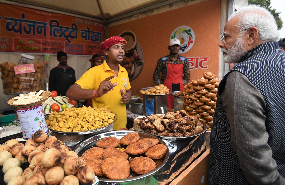 PeoplesGovIN's tweet photo. PM Narendra Modi enjoying tasty Litti Chokha for lunch along with a hot cup of tea at #HunarHaat. | @narendramodi https://t.co/S2ObXv3PQs