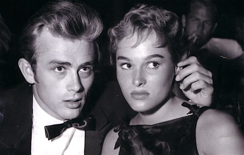 Bisexual celebrity couples: An image of actor James Dean and Ursula Andress. It's a black and white image and both people are very attractive, looking at the camera with uncertain faces.