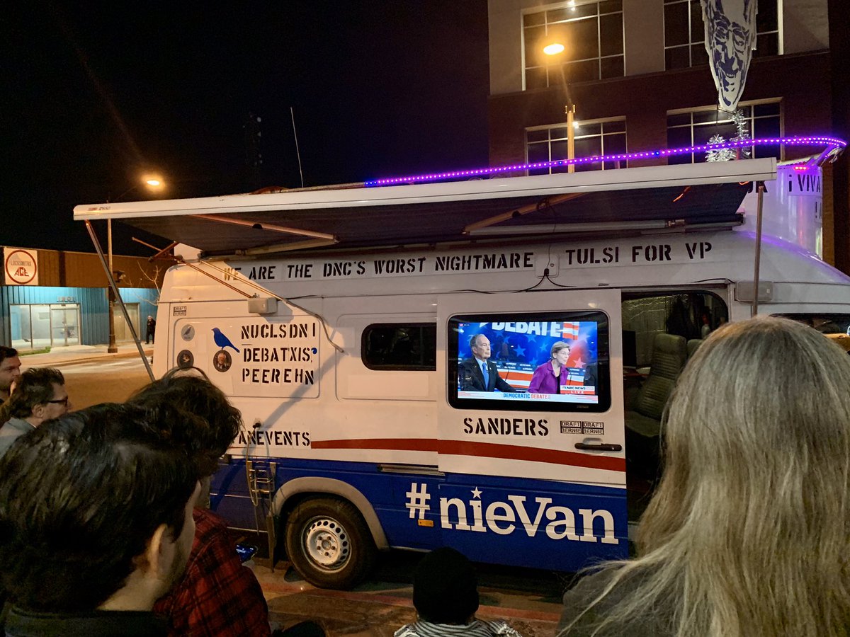 JackieValley's tweet photo. Where there’s a will, there’s a way... the #BernieVan has pulled to the front of Tacotarian and is playing the debate while livestream issues were happening inside. (It’s back on inside now, too.) https://t.co/fSLLinrB5l