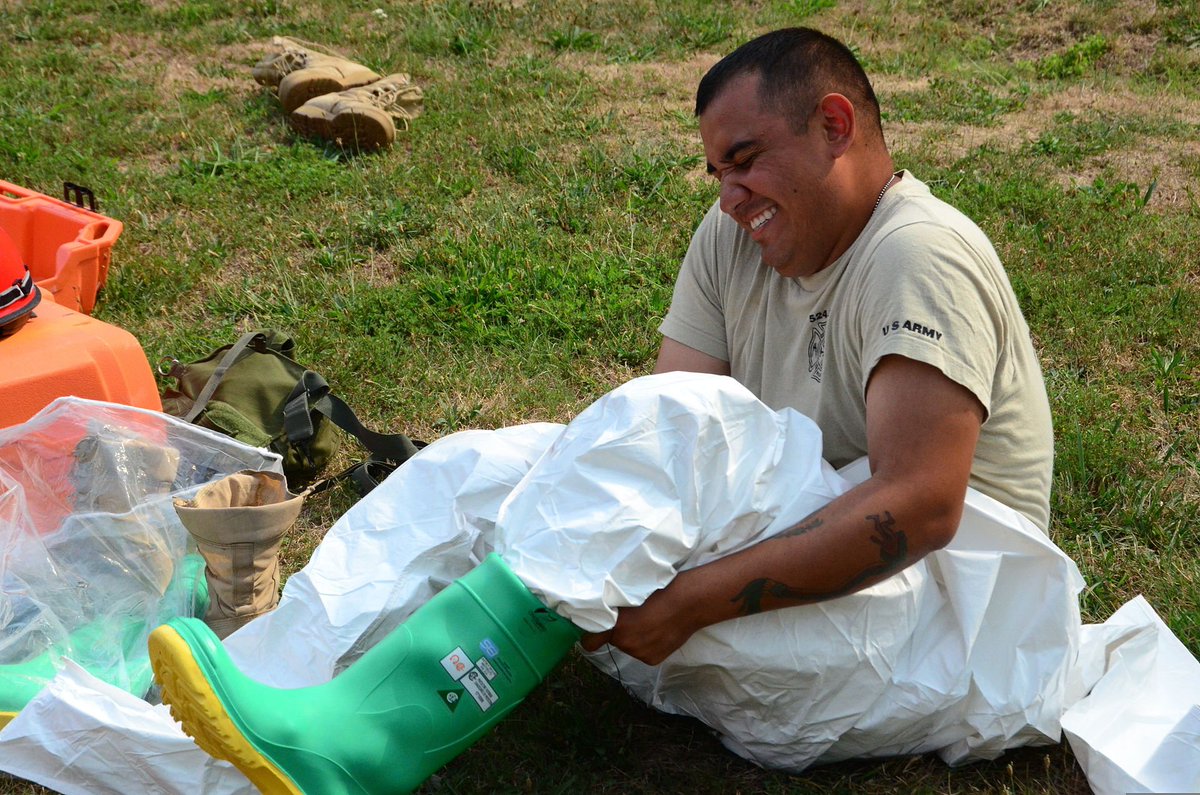 U.S. Army Pfc. Idaim Robles, a firefighter with the 178th Technical Rescue Company, 46th Engineer Battalion, struggles with his chemical overshoe boots during search and rescue training at the Muscatatuck Urban Training Center in Butlerville, Ind