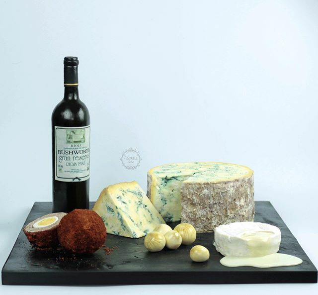 EstreleCakes's tweet photo. Here is a photo of my favourite cake at the moment.... a 40th  birthday cake. A rice crispie cake bottle of Rioja, cake pop mix scotch egg, sugar pickled onions and chocolate cake cheeses.
#itsalledible #edibleart #cheesecake #winecake #yorkshirecakedecorator  #rioja #stilto… https://t.co/Y9L9bDU2I4